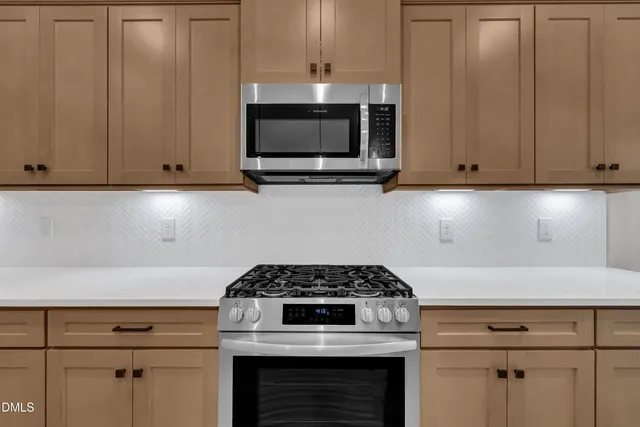 a stove top oven sitting inside of a kitchen