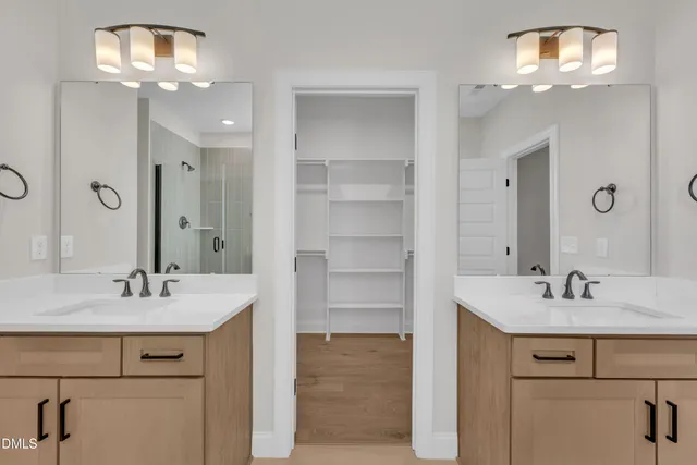 a bathroom with a sink double vanity and a mirror