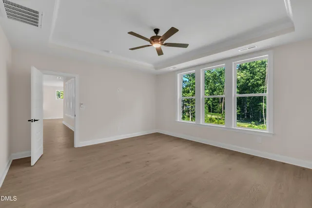 a view of a livingroom with a ceiling fan and window