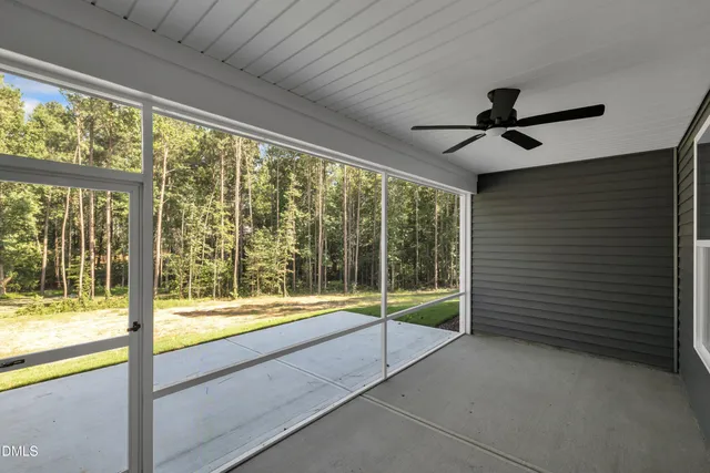 a view of room with window and a ceiling fan