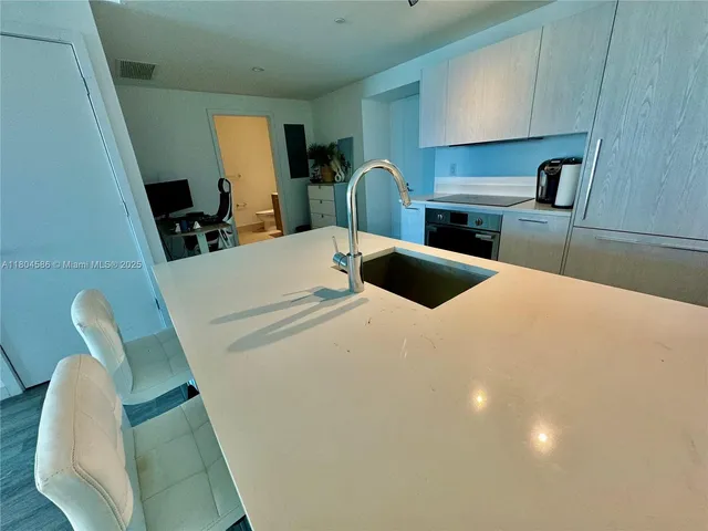 a bedroom with a bed and a dresser with mirror