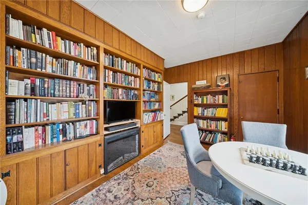 a living room with furniture and a book shelf