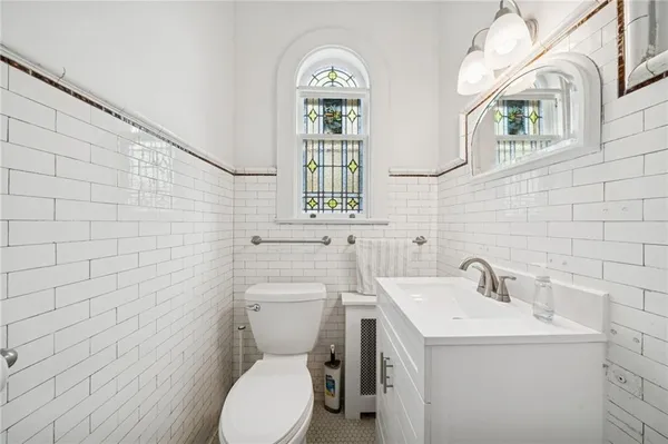 a bathroom with a toilet sink and mirror