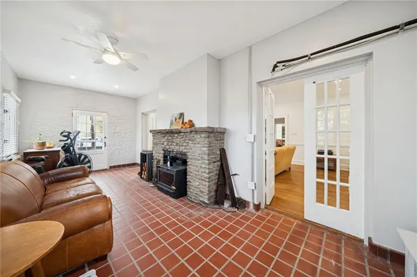 a living room with furniture a fireplace and a window