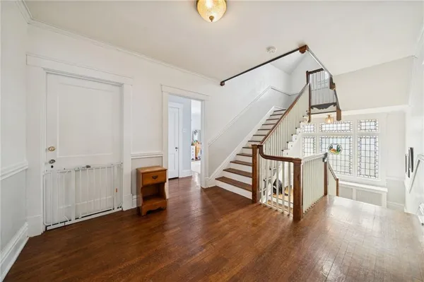 a view of entryway with wooden floor and stairs