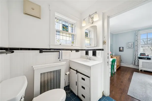 a bathroom with a toilet a sink and a mirror