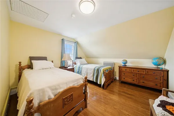 a bedroom with two beds and painted walls