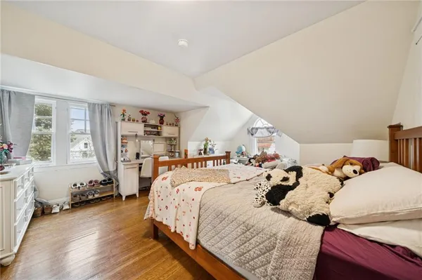 a bed room with two bed and a chair