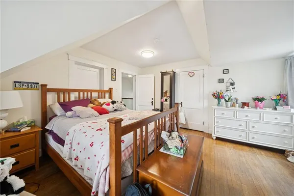 a bedroom with a bed and a dresser