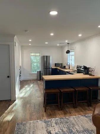 a living room with furniture a dining table and kitchen view
