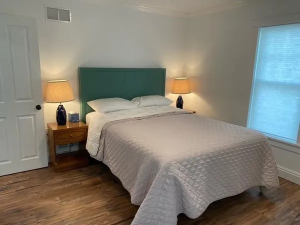 a bedroom with a bed and a lamp