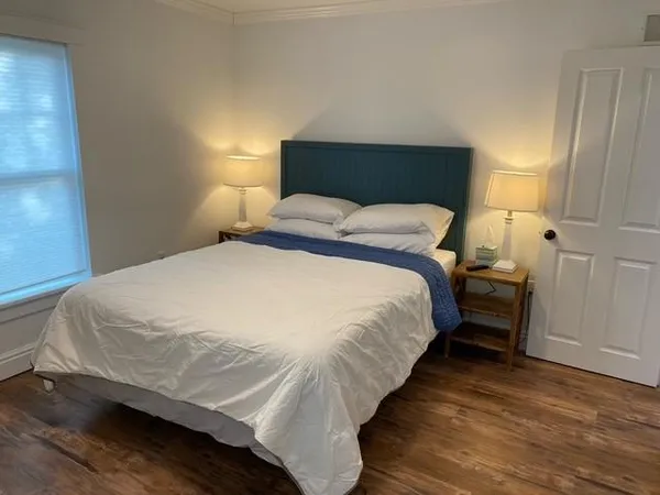 a bedroom with a bed and a night stand