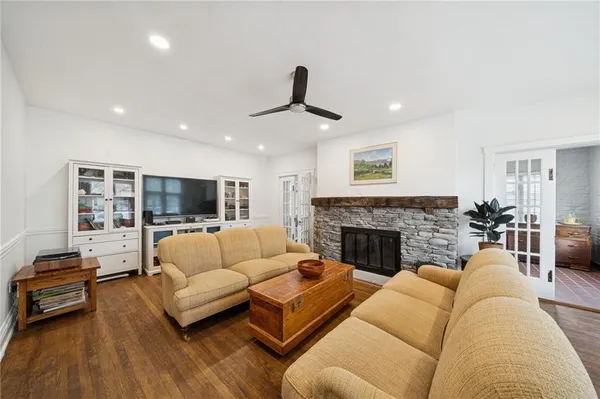 a living room with furniture fireplace and flat screen tv