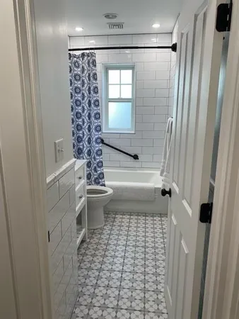 a bathroom with a toilet and a shower