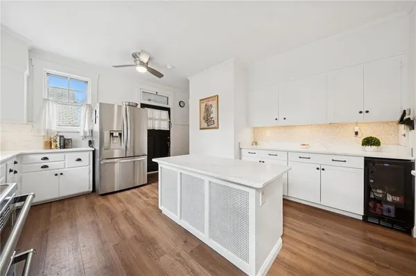 a kitchen with white cabinets and white appliances