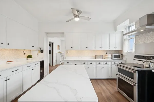 a kitchen with cabinets stainless steel appliances and a window