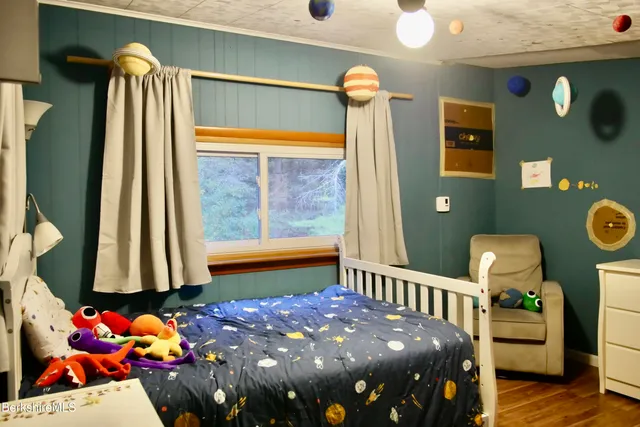 a bedroom with a bed and a window