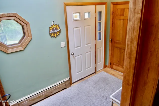 a view of an entryway with wooden floor