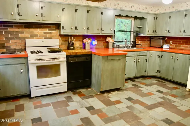a kitchen with stainless steel appliances granite countertop a sink and cabinets