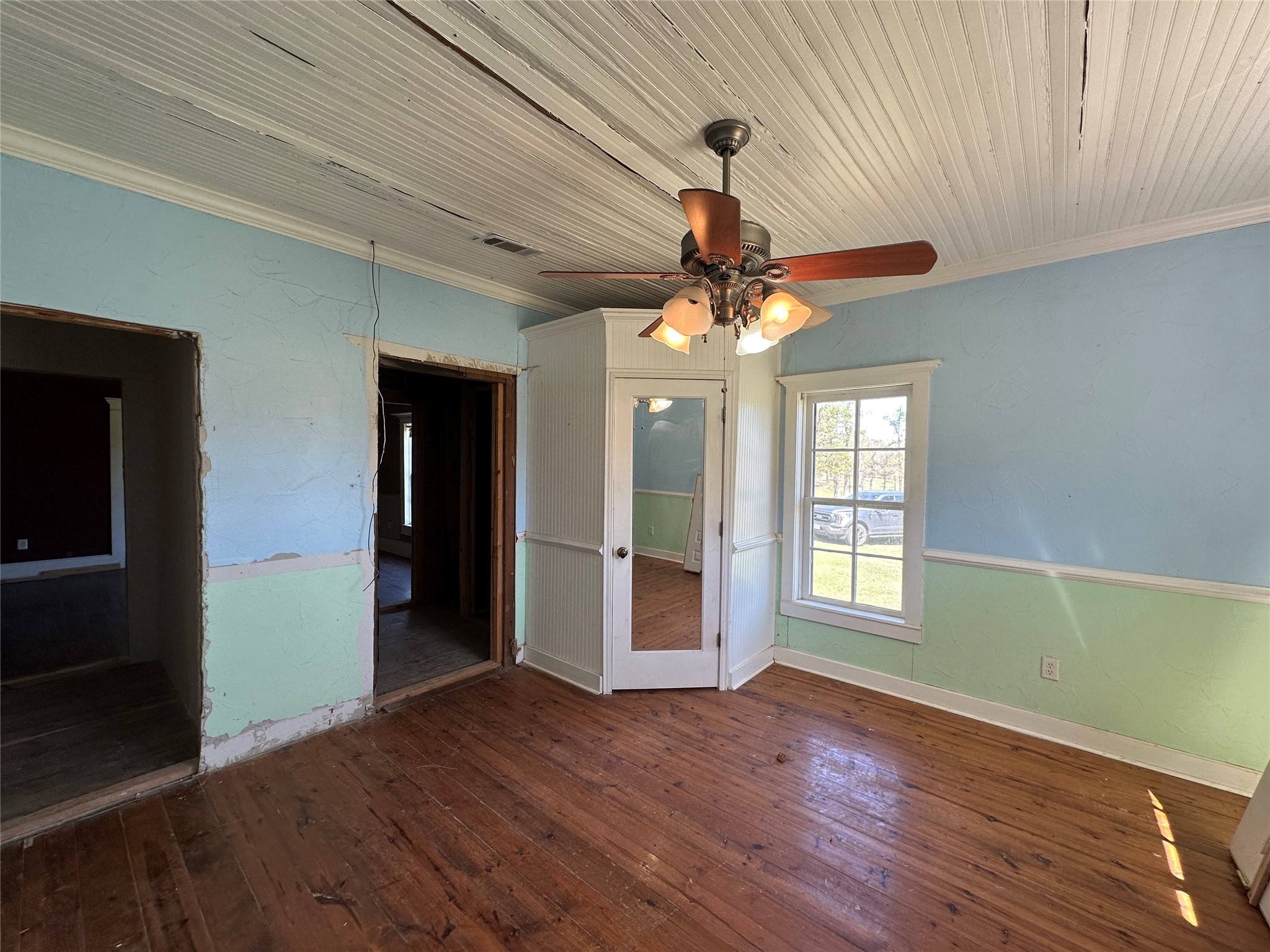 8773 I-45 Street South Centerville, TX 75833 - Photo 11 of 35 a view of an empty room with wooden floor and a window