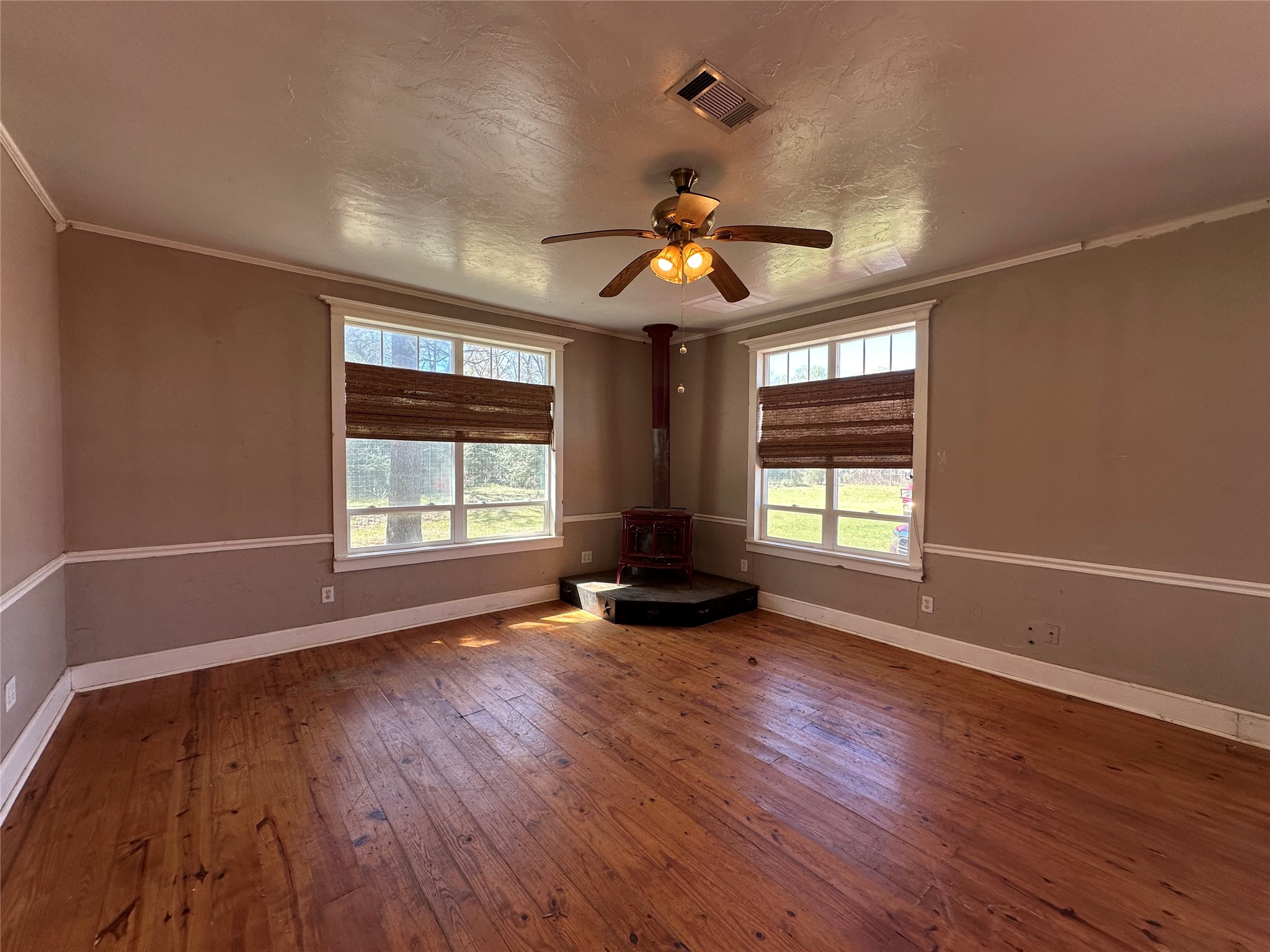 8773 I-45 Street South Centerville, TX 75833 - Photo 16 of 35 a view of an empty room with wooden floor and a window