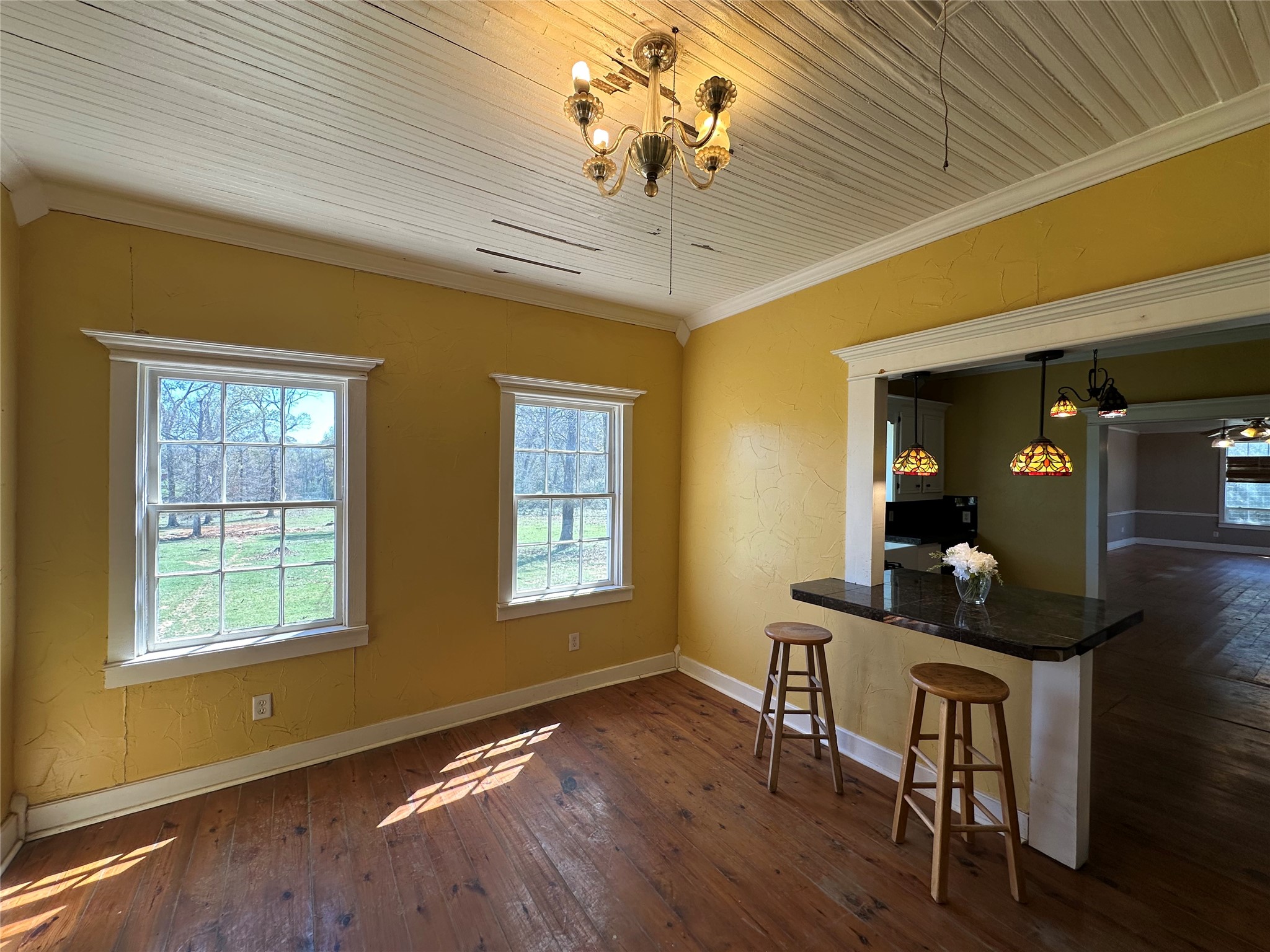 8773 I-45 Street South Centerville, TX 75833 - Photo 8 of 35 a dining room with wooden floor a chandelier a wooden table and chairs