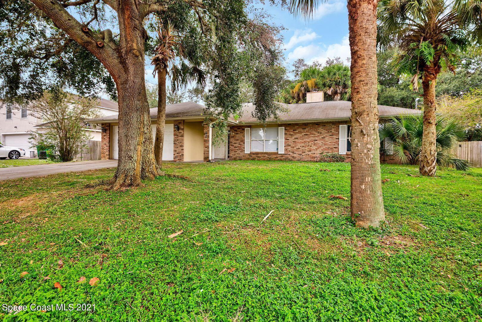 6025 Adina Road Cocoa, FL 32927 - Photo 2 of 22 a view of a house with a yard and tree s
