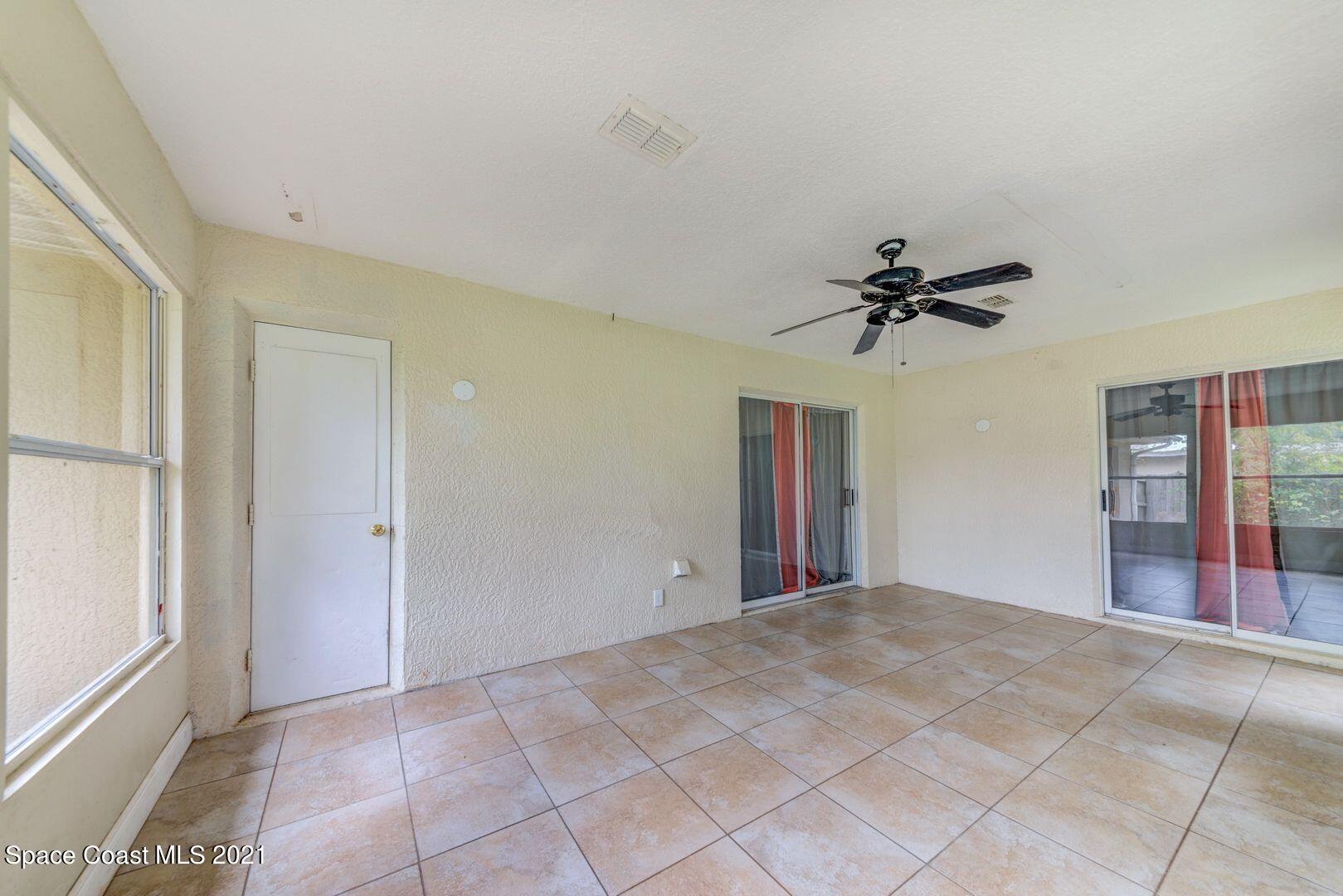 6025 Adina Road Cocoa, FL 32927 - Photo 11 of 22 a view of a room with a ceiling fan and window