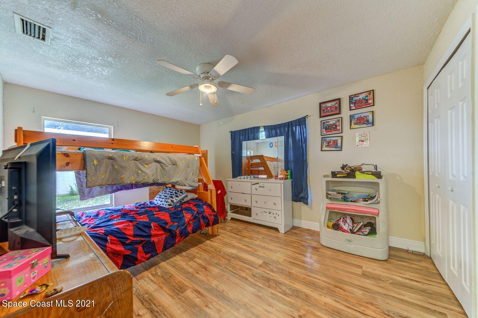 6025 Adina Road Cocoa, FL 32927 - Photo 17 of 22 a bedroom with bed and furniture