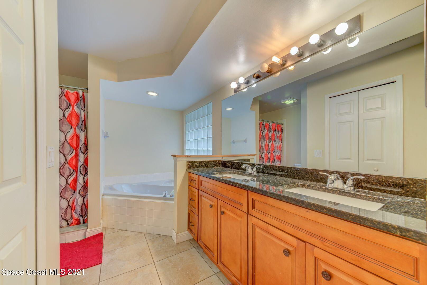 6025 Adina Road Cocoa, FL 32927 - Photo 18 of 22 a bathroom with a sink vanity and a mirror