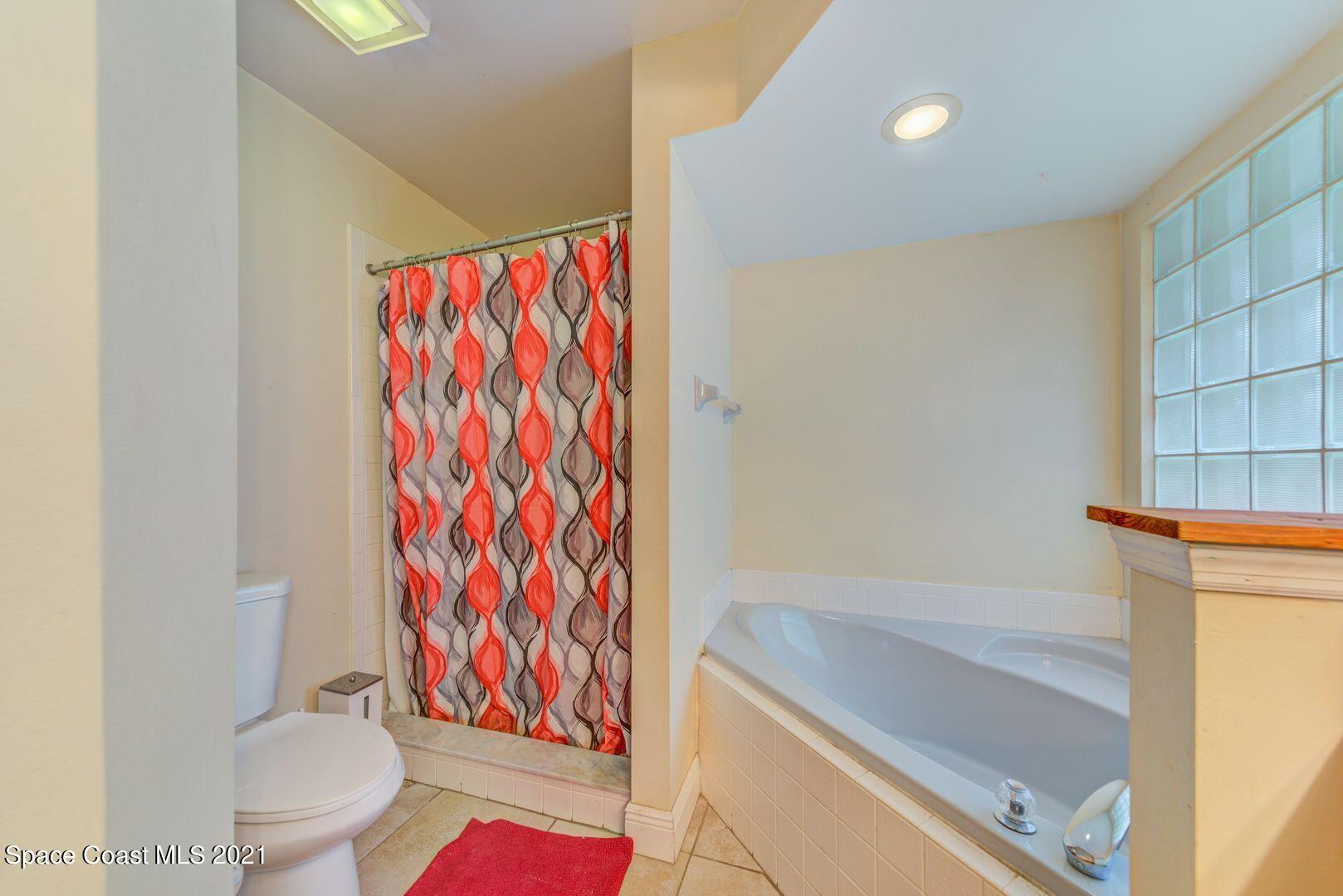 6025 Adina Road Cocoa, FL 32927 - Photo 19 of 22 a bathroom with a bathtub and shower