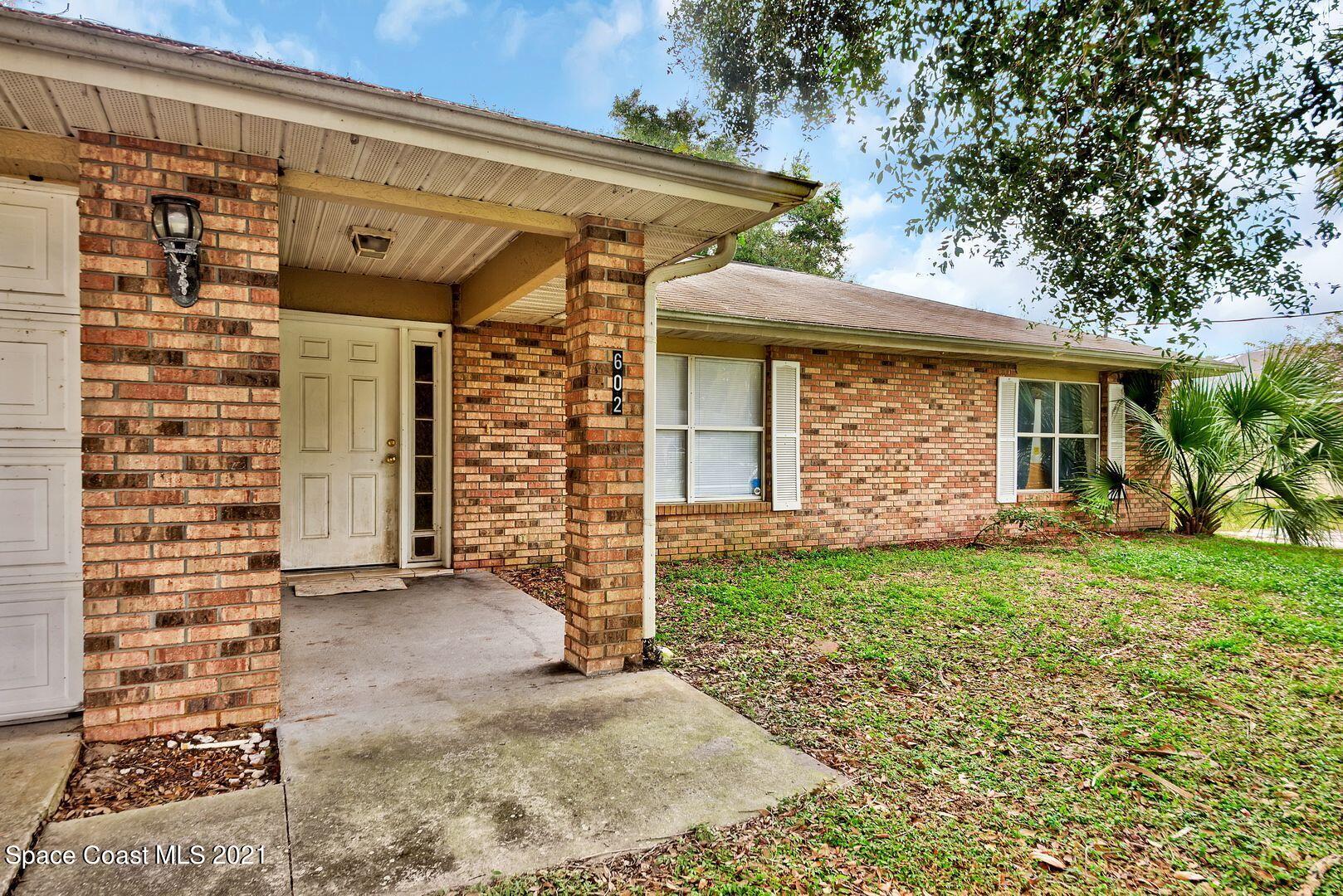 6025 Adina Road Cocoa, FL 32927 - Photo 3 of 22 front view of a house with a large tree