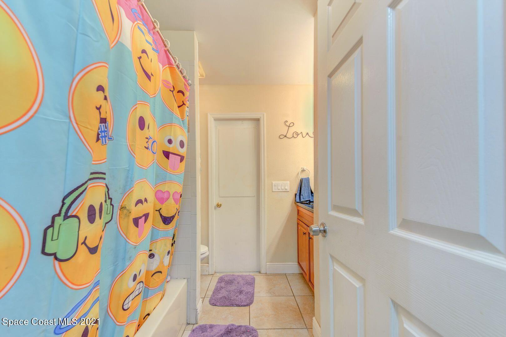 6025 Adina Road Cocoa, FL 32927 - Photo 22 of 22 a bathroom with a bathtub and shower curtain