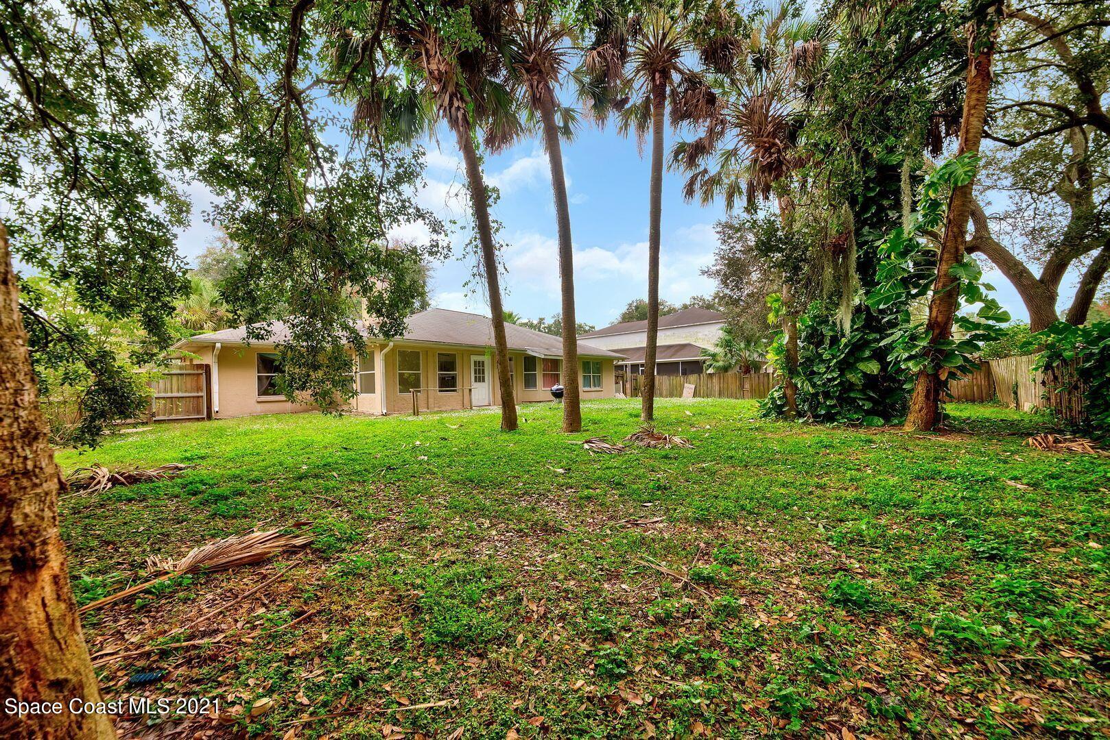 6025 Adina Road Cocoa, FL 32927 - Photo 4 of 22 a view of a yard with plants and large trees