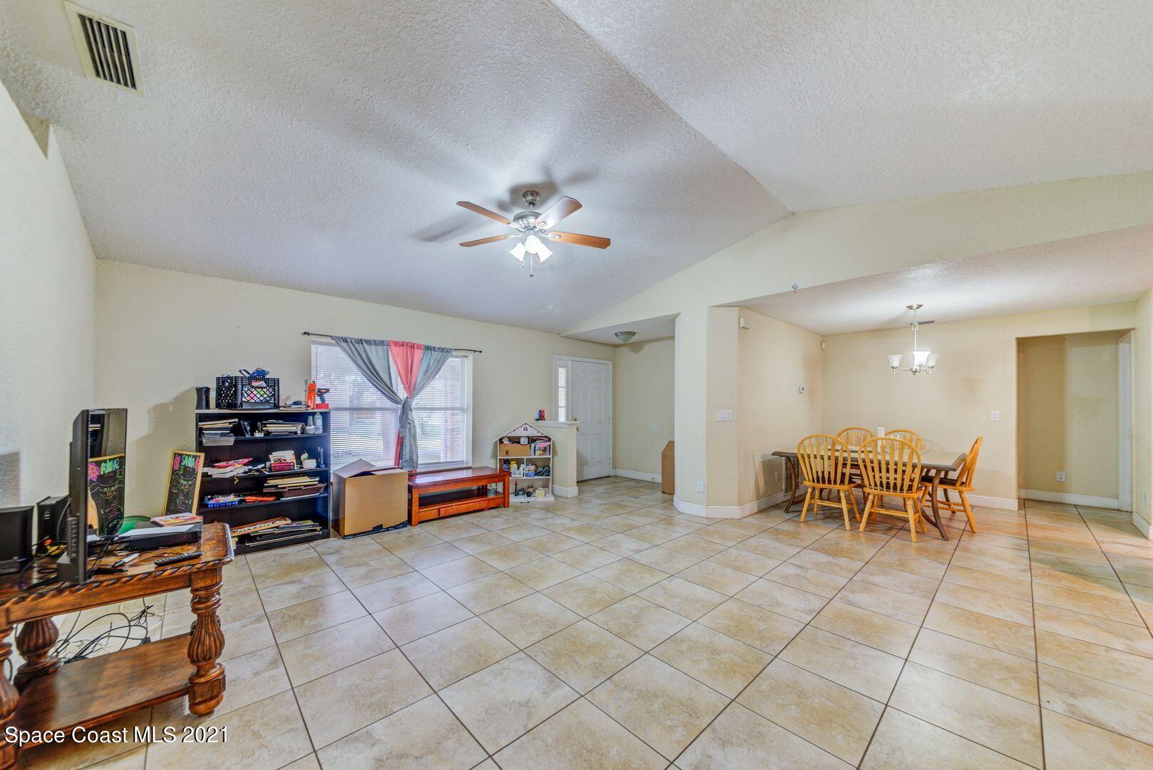 6025 Adina Road Cocoa, FL 32927 - Photo 5 of 22 a bedroom with furniture and a gym equipment