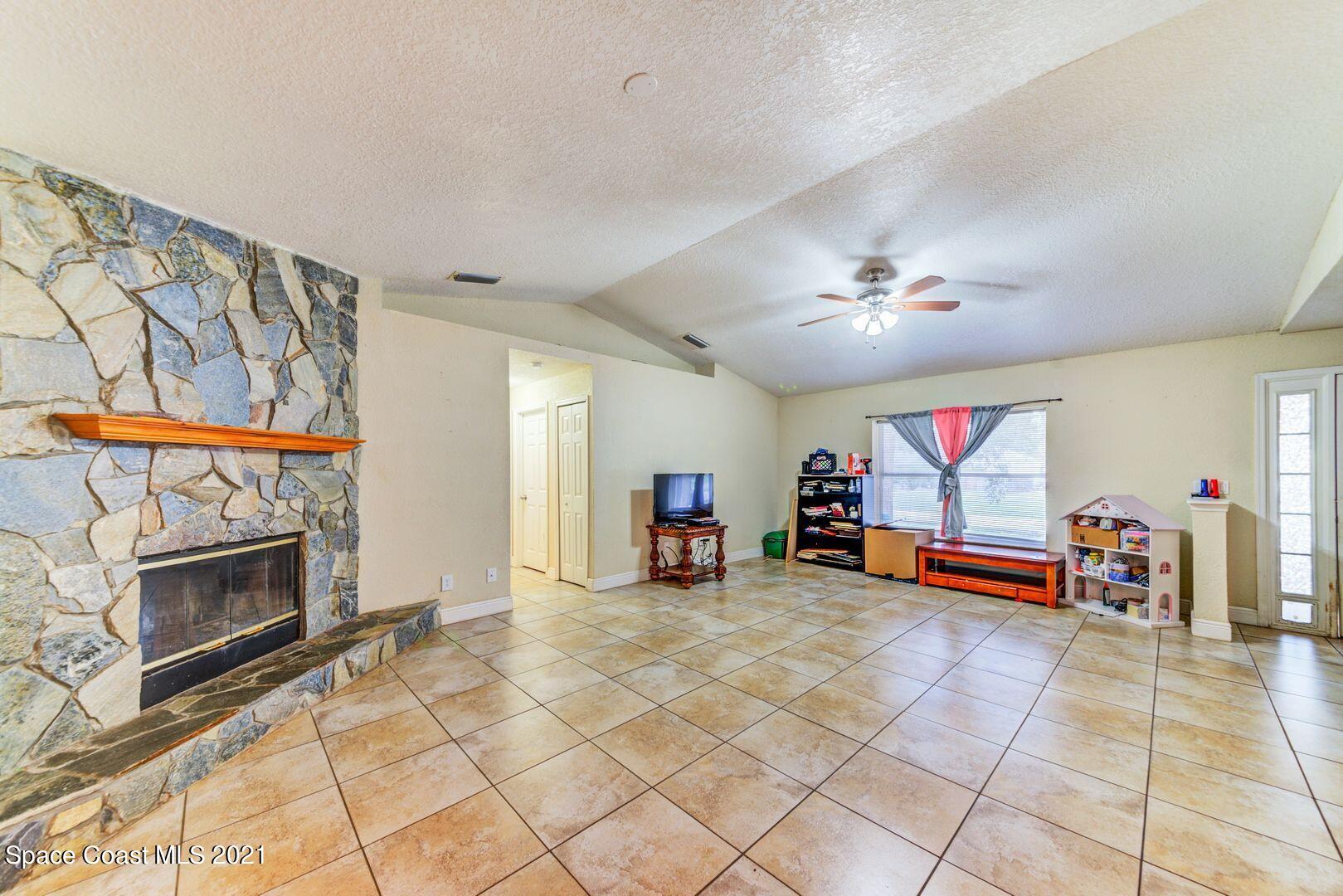6025 Adina Road Cocoa, FL 32927 - Photo 7 of 22 a view of a livingroom with furniture and a fireplace