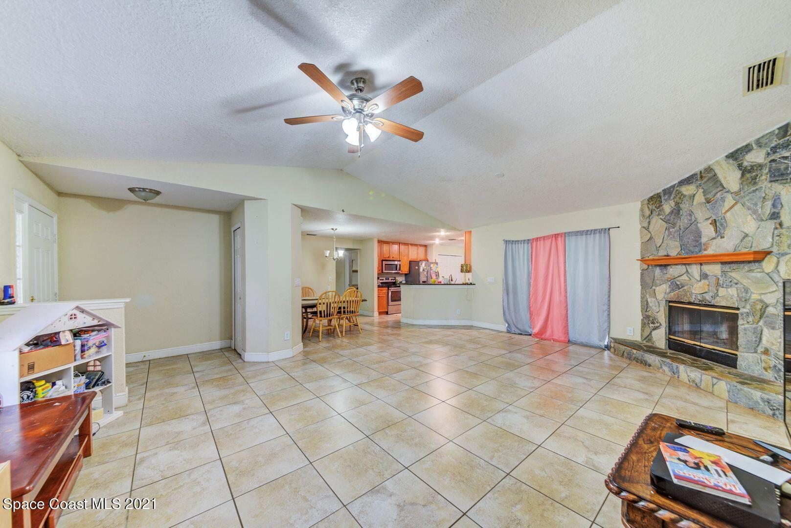 6025 Adina Road Cocoa, FL 32927 - Photo 8 of 22 a view of a livingroom with furniture and a fireplace