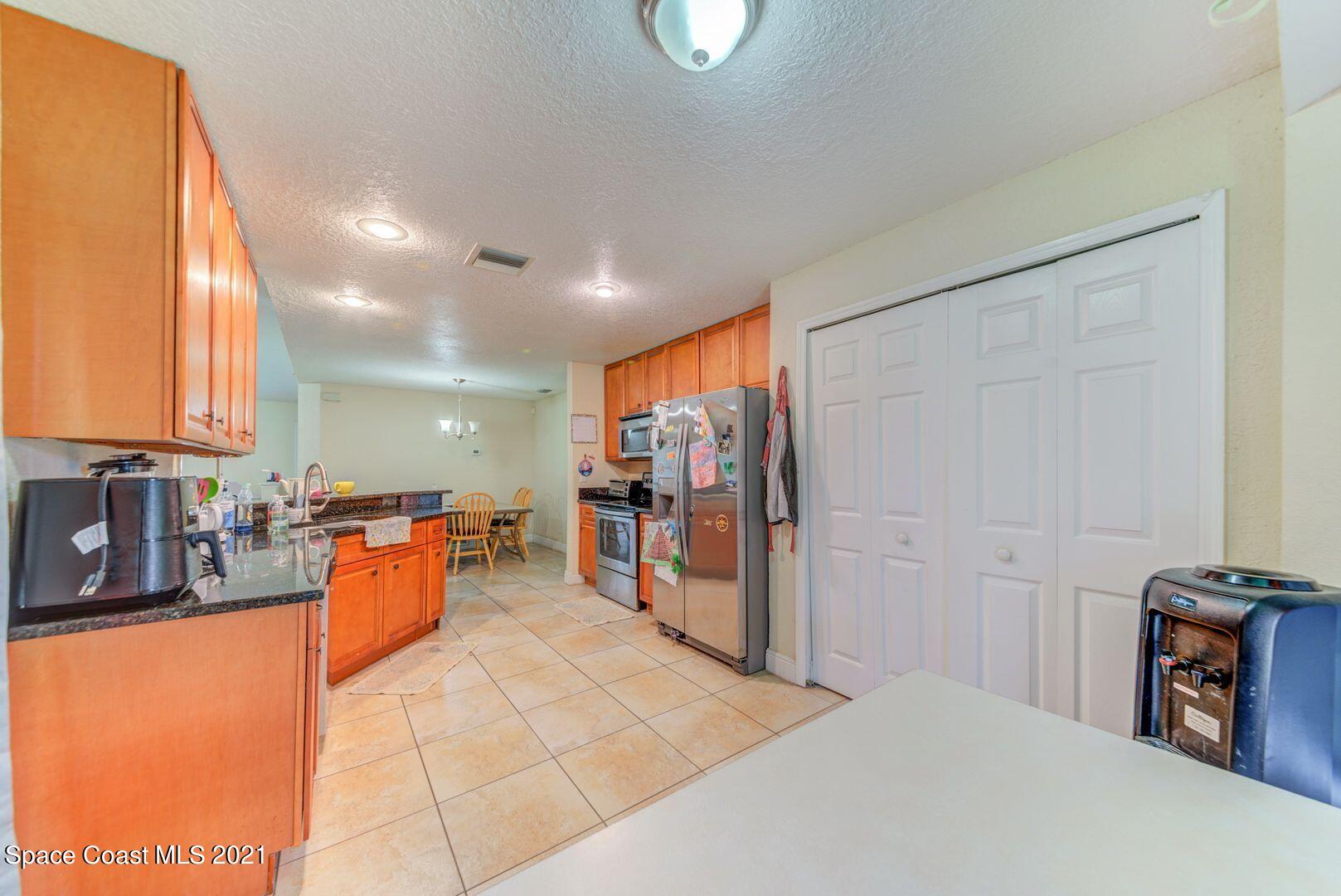 6025 Adina Road Cocoa, FL 32927 - Photo 10 of 22 a bedroom with furniture and a refrigerator