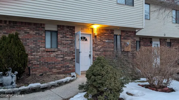 a view of a brick house with a large windows