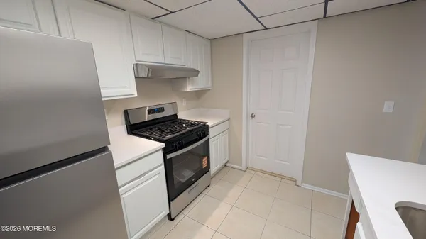 a kitchen with cabinets and white appliances