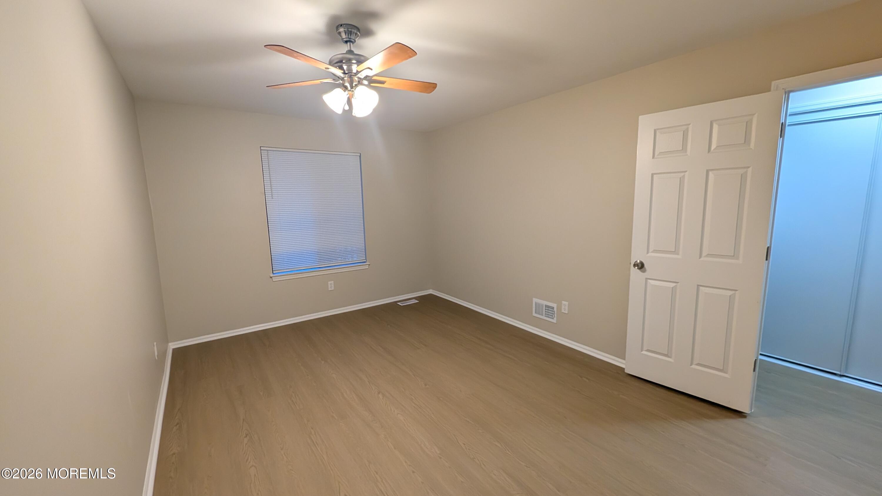 21 Jesse Road Howell, NJ 07731 - Photo 18 of 30 wooden floor in an empty room with a window
