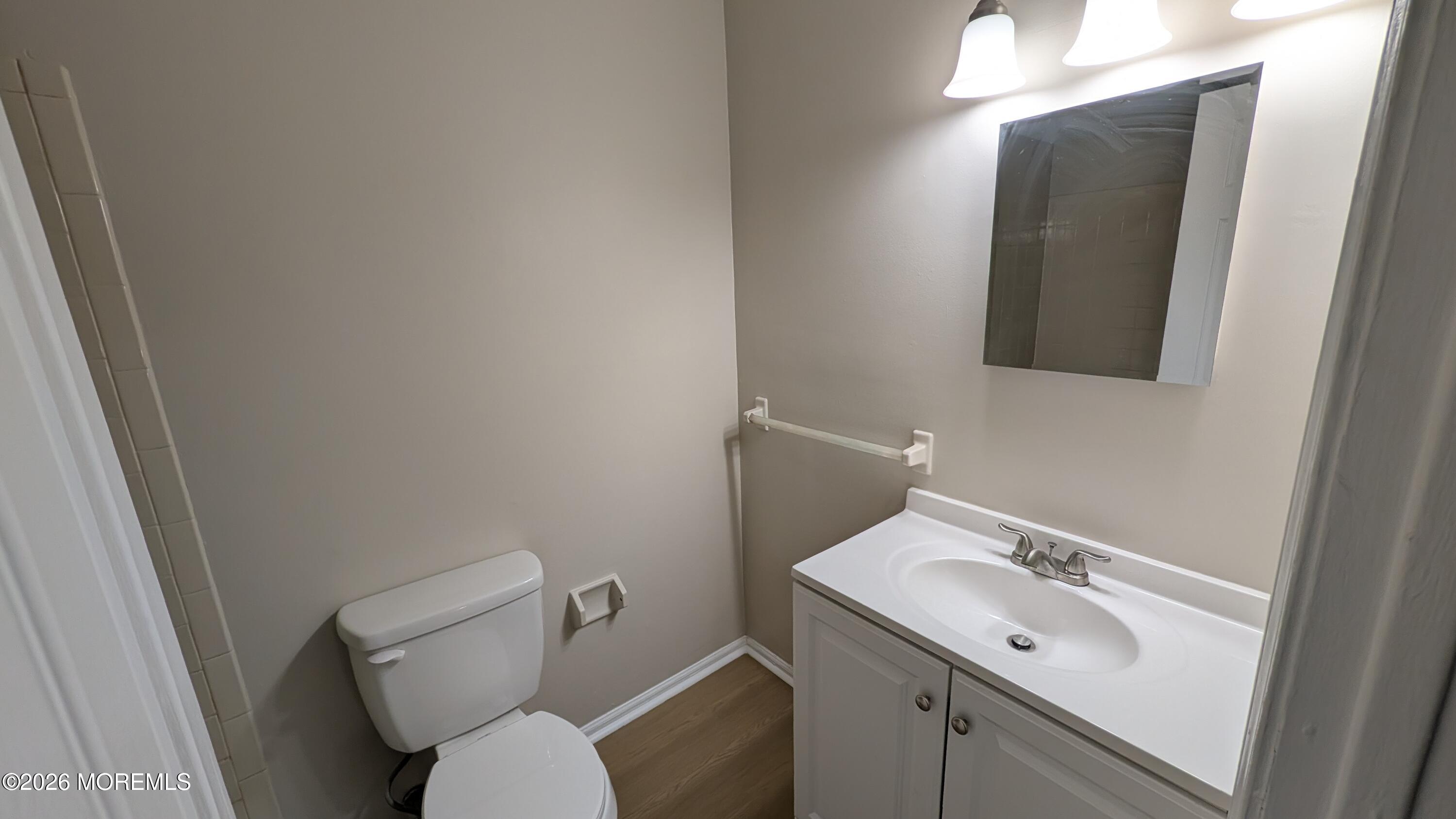 21 Jesse Road Howell, NJ 07731 - Photo 25 of 30 a bathroom with a toilet sink and mirror