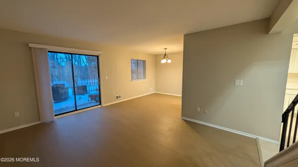an empty room with windows and entrance