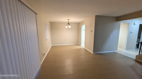 an empty room with windows and entrance