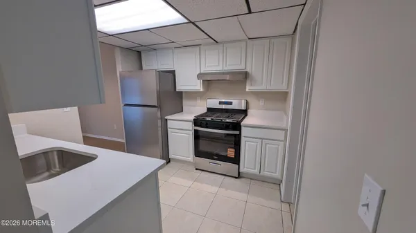 a kitchen with stainless steel appliances a stove a sink and a refrigerator
