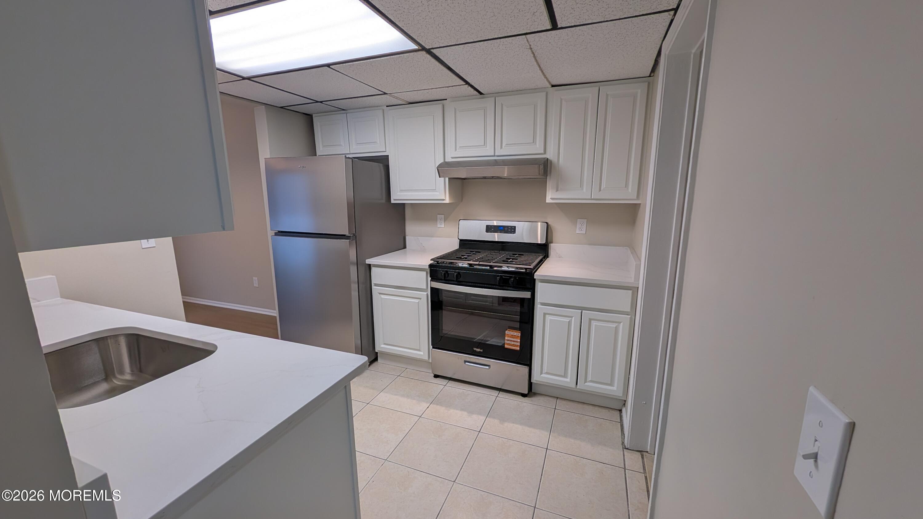 21 Jesse Road Howell, NJ 07731 - Photo 7 of 30 a kitchen with stainless steel appliances a stove a sink and a refrigerator