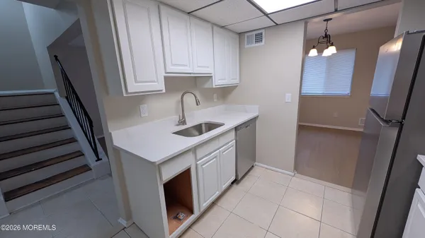 a kitchen with a sink and cabinets