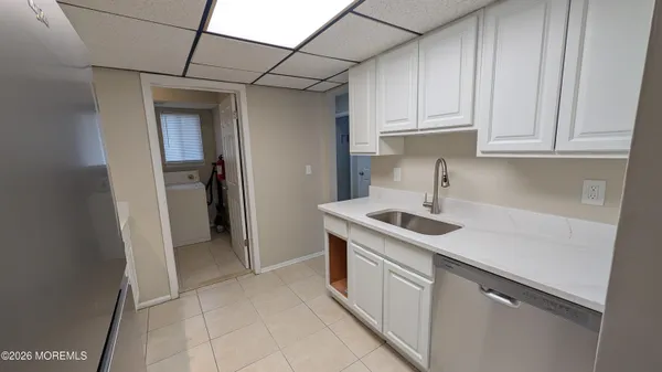 a kitchen with stainless steel appliances granite countertop a sink and a refrigerator