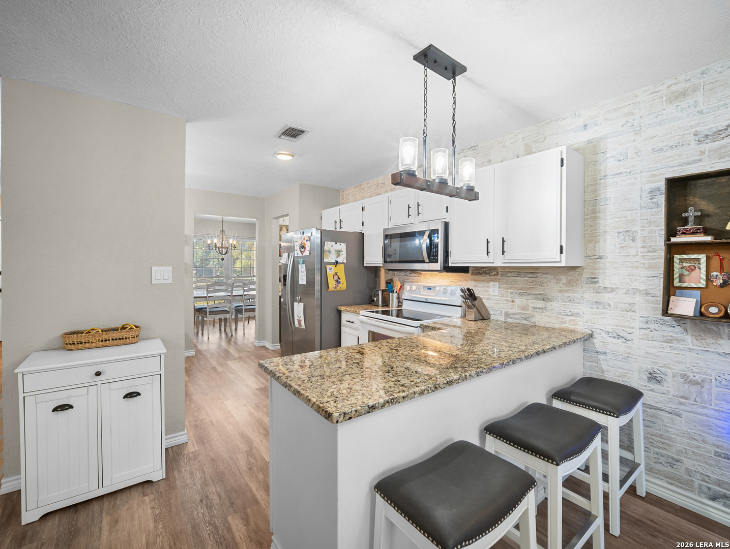 3620 Chestnut Court Cibolo, TX 78108 - Photo 11 of 45 a kitchen with granite countertop kitchen island white cabinets and stainless steel appliances