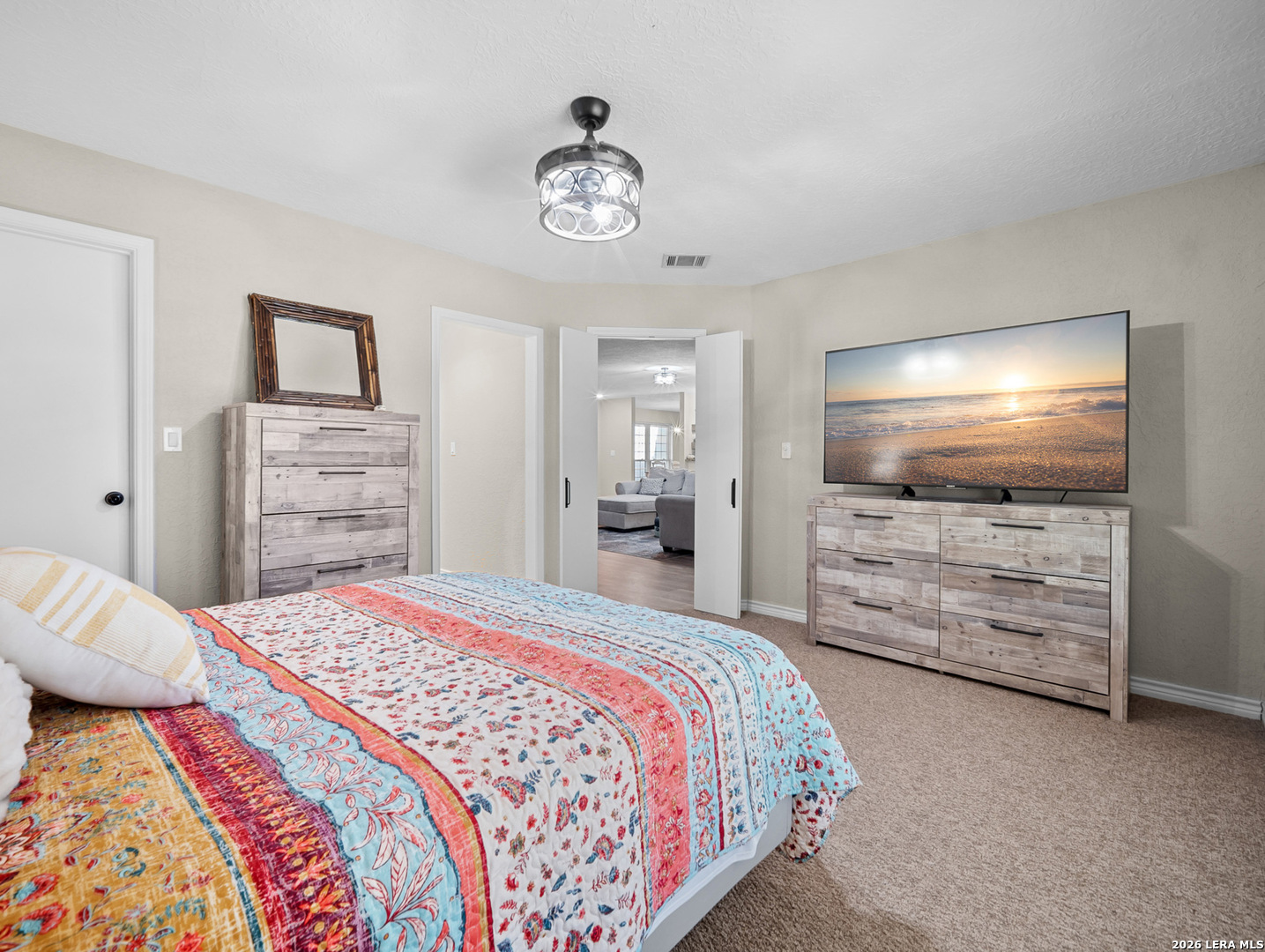 3620 Chestnut Court Cibolo, TX 78108 - Photo 28 of 45 a bedroom with a bed and a flat screen tv in white walls